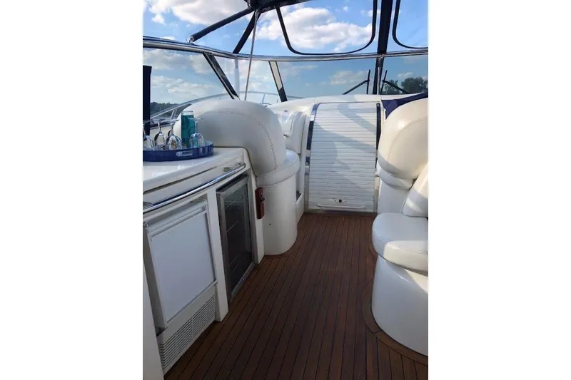 Slide: The Image of Interior of 1998 Sunseeker Predator 58 yacht with white seating and wooden flooring. - 26