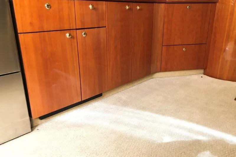 Slide: The Image of Interior of 1998 Sunseeker Predator 58 yacht with wooden cabinets and beige carpet. - 38