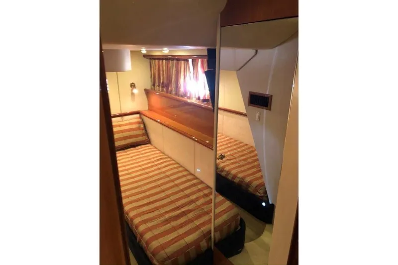 Slide: The Image of Cozy cabin interior of 1998 Sunseeker Predator 58 yacht with striped bedding. - 40