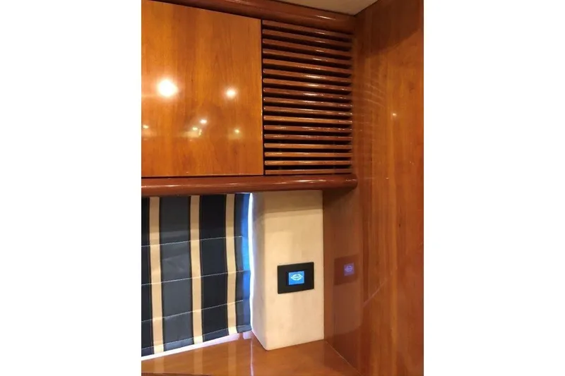 Slide: The Image of Interior of 1998 Sunseeker Predator 58 yacht with wood paneling and striped curtain. - 42