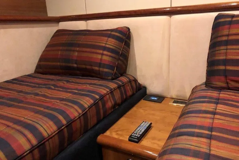 Slide: The Image of Twin beds with plaid bedding in a 1998 Sunseeker Predator 58 yacht cabin. - 45