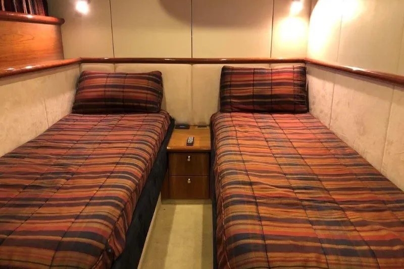 Slide: The Image of Twin beds in a cozy cabin of a 1998 Sunseeker Predator 58 yacht. - 46