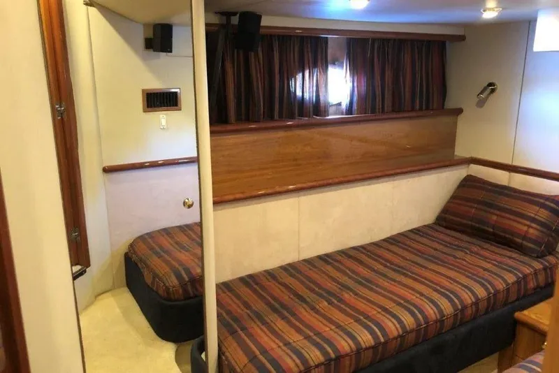 Slide: The Image of Interior cabin of 1998 Sunseeker Predator 58 yacht with striped bedding. - 49