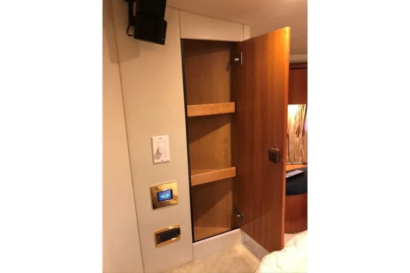 Slide: The Image of Interior of 1998 Sunseeker Predator 58 yacht with open wooden cabinet. - 52