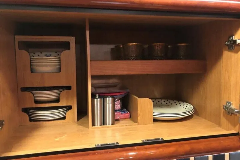 Slide: The Image of Cabinet interior on 1998 Sunseeker Predator 58 yacht, featuring organized dishes and cups. - 55