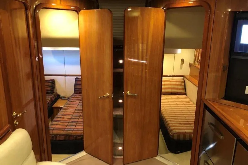Slide: The Image of Interior of 1998 Sunseeker Predator 58 yacht with twin beds and wooden finishes. - 58