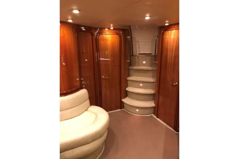 Slide: The Image of Luxurious interior of 1998 Sunseeker Predator 58 yacht with elegant wood paneling and plush seating. - 59
