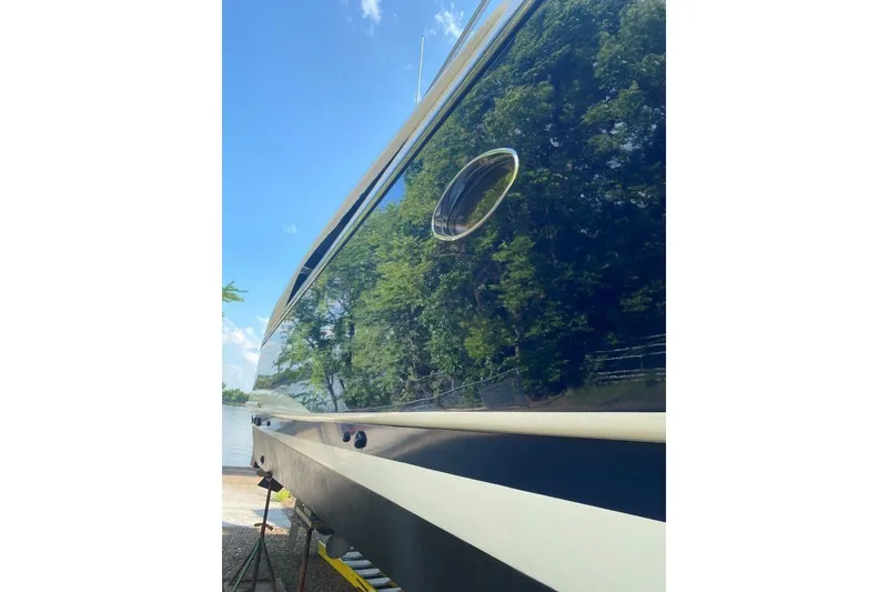 Slide: The Image of Side view of a 1998 Sunseeker Predator 58 yacht reflecting trees and sky. - 8