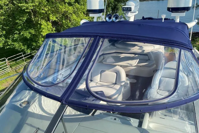 Slide: The Image of 1998 Sunseeker Predator 58 yacht with blue canopy and luxurious interior seating. - 9