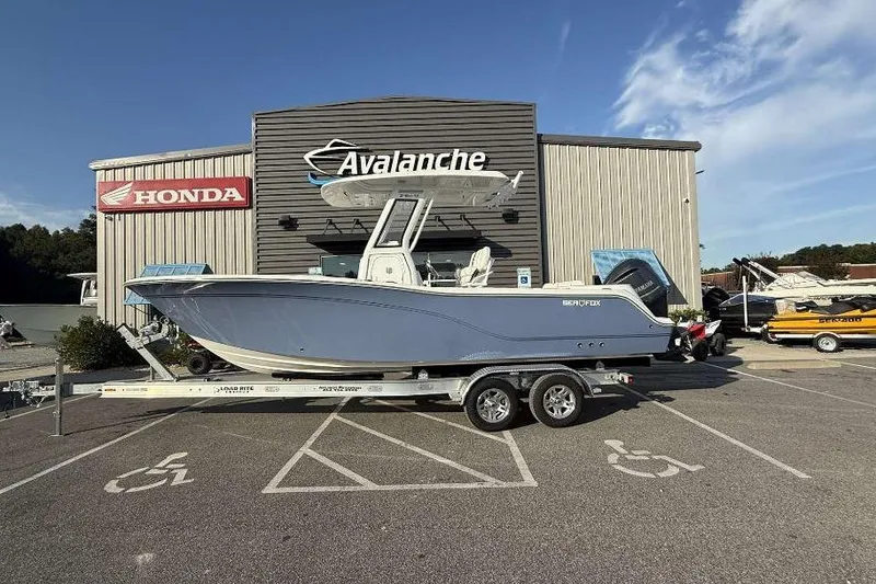 Slide: The Image of 2026 Sea Fox 248 Commander boat on trailer outside dealership, clear sky background. - 10