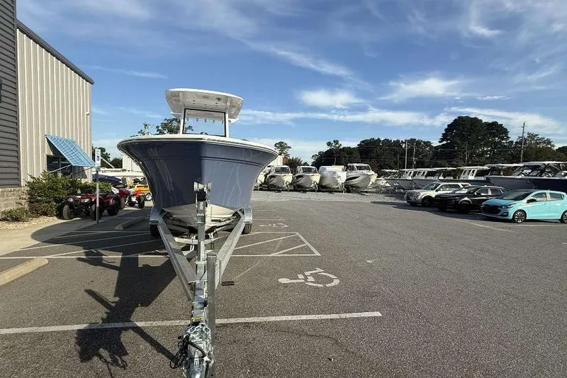 Slide: The Image of 2026 Sea Fox 248 Commander boat on trailer in parking lot, clear sky background. - 11