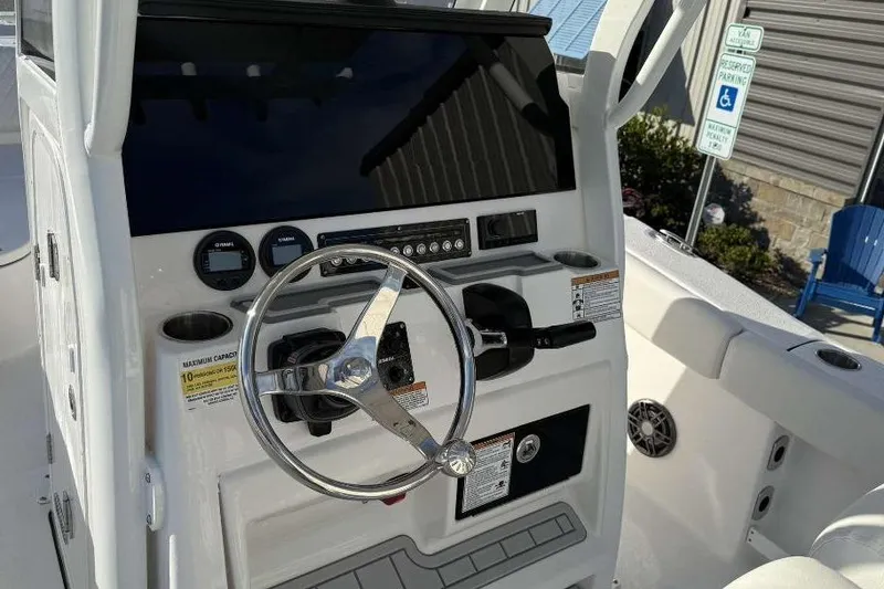 Slide: The Image of 2026 Sea Fox 248 Commander boat dashboard with steering wheel and controls. - 13