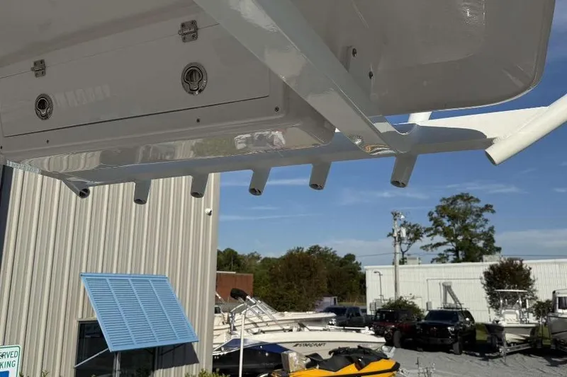 Slide: The Image of 2026 Sea Fox 248 Commander boat detail with rod holders and storage, outdoor setting. - 14
