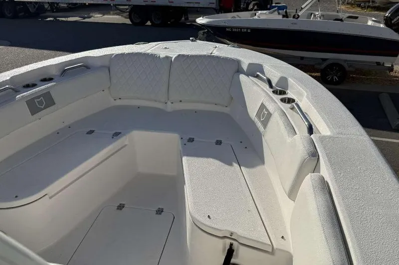 Slide: The Image of 2026 Sea Fox 248 Commander boat interior with cushioned seating and storage compartments. - 16