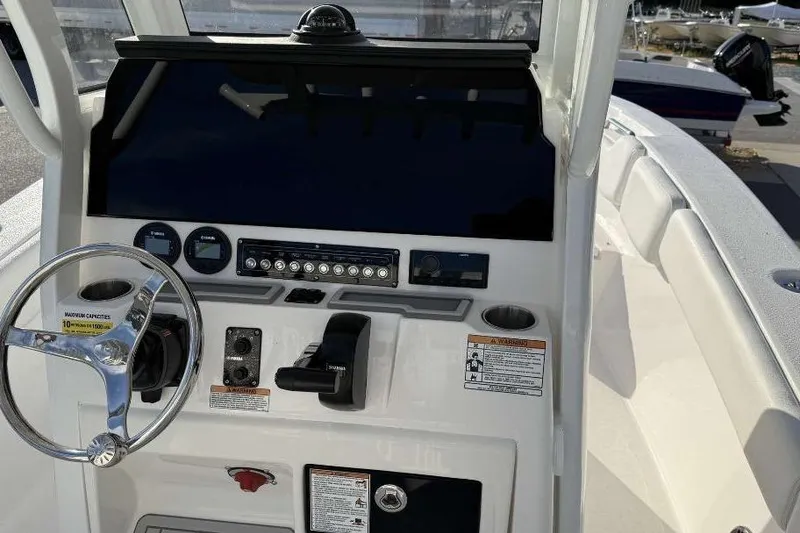 Slide: The Image of 2026 Sea Fox 248 Commander boat dashboard with steering wheel and controls. - 22