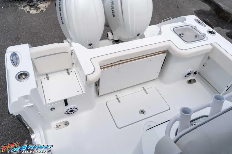Slide: The Image of 2026 Sea Hunt Gamefish 25 boat deck with Yamaha engines, featuring storage and seating. - 11