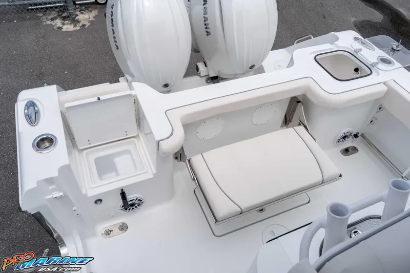 Slide: The Image of 2026 Sea Hunt Gamefish 25 boat interior with Yamaha engines, featuring seating and storage compartments. - 12
