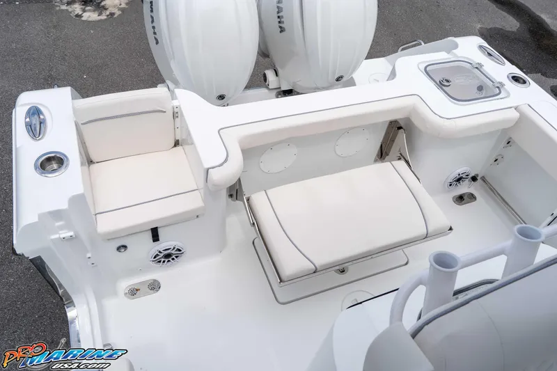Slide: The Image of 2026 Sea Hunt Gamefish 25 boat interior with seating and Yamaha engines. - 13