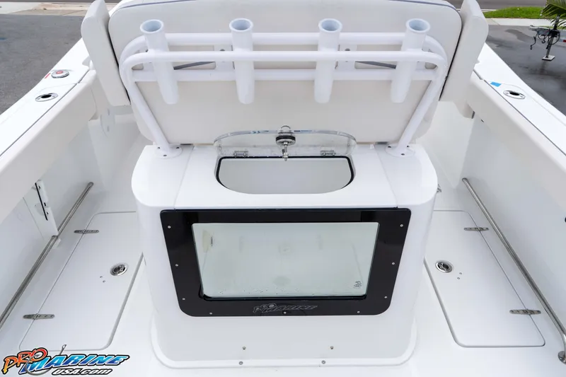 Slide: The Image of 2026 Sea Hunt Gamefish 25 boat interior with rod holders and livewell. - 14