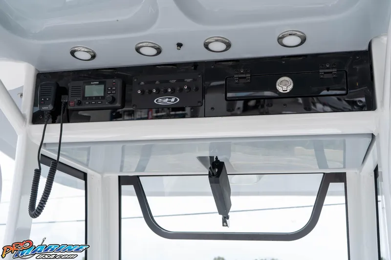Slide: The Image of 2026 Sea Hunt Gamefish 25 console with Garmin radio and control panel. - 19