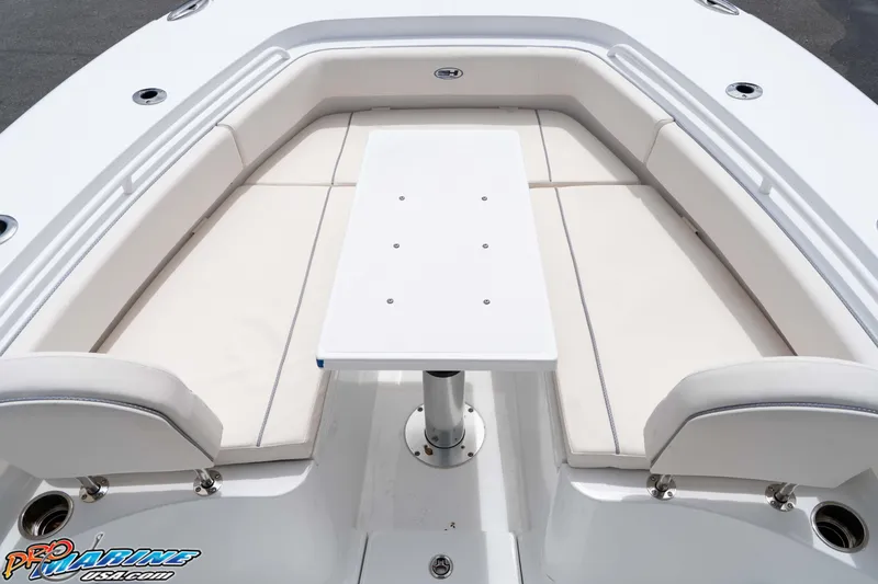 Slide: The Image of 2026 Sea Hunt Gamefish 25 boat interior with cushioned seating and table. - 24