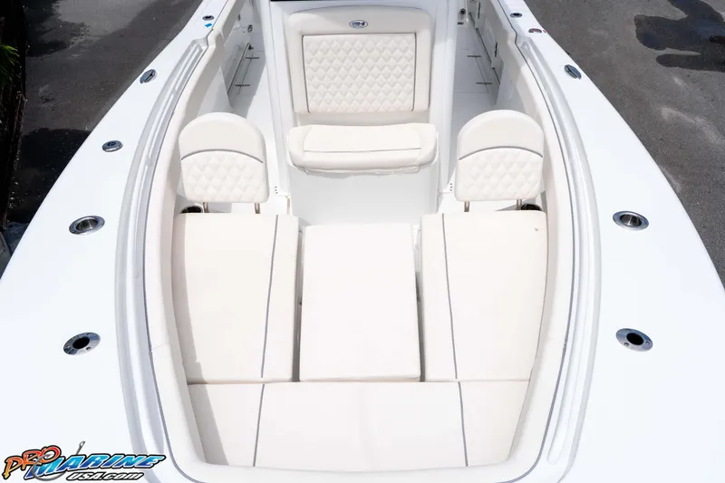 Slide: The Image of 2026 Sea Hunt Gamefish 25 boat interior with white cushioned seating and sleek design. - 26