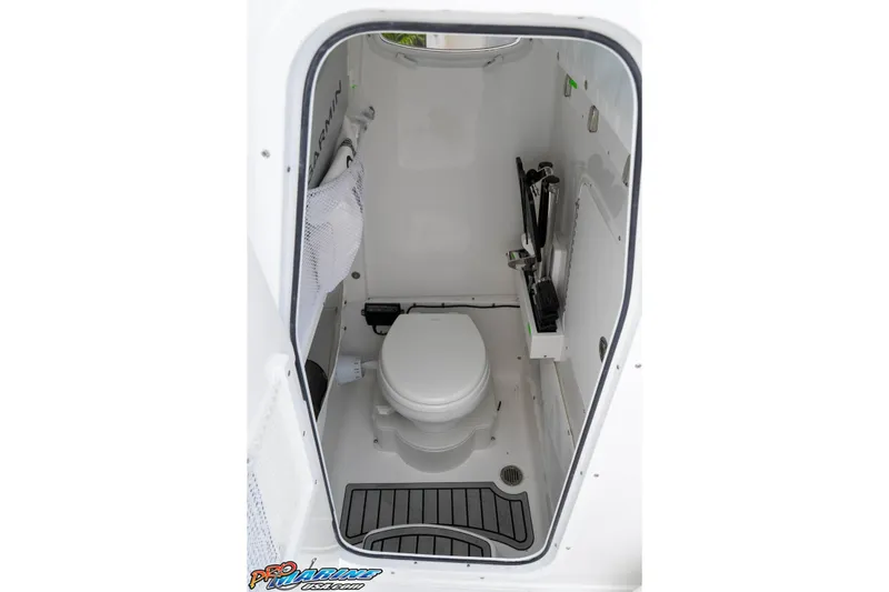 Slide: The Image of Interior of 2026 Sea Hunt Gamefish 25 boat, featuring a compact marine toilet. - 28