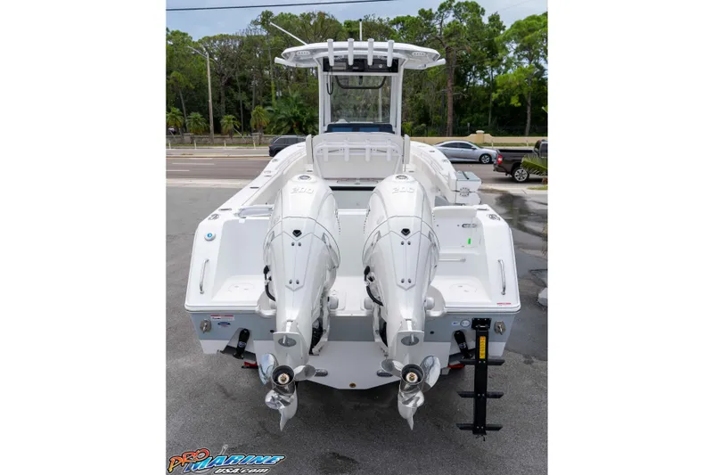 Slide: The Image of 2026 Sea Hunt Gamefish 25 boat with dual outboard engines, parked on a lot. - 5