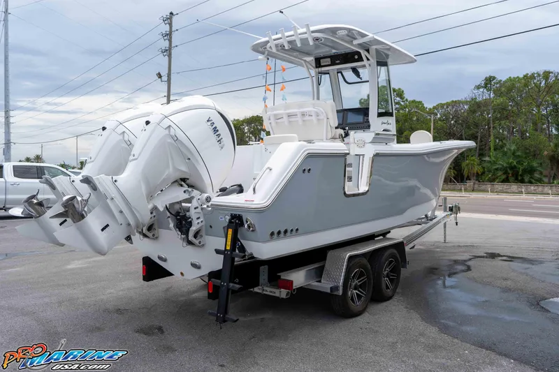Slide: The Image of 2026 Sea Hunt Gamefish 25 boat on trailer with dual Yamaha engines. - 7