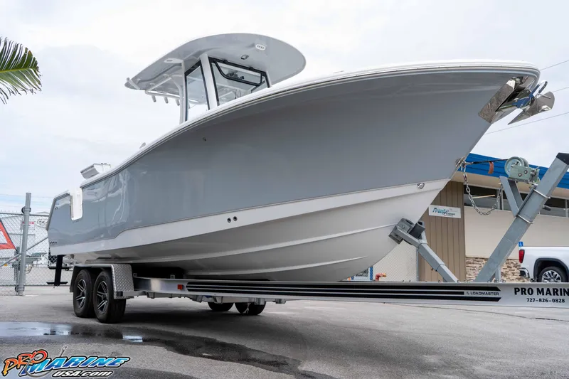 Slide: The Image of 2026 Sea Hunt Gamefish 25 boat on trailer, displayed outdoors at Pro Marine USA. - 8