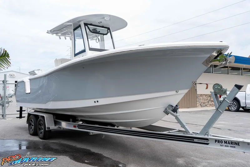 Slide: The Image of 2026 Sea Hunt Gamefish 25 boat on trailer at Pro Marine dealership. - 9