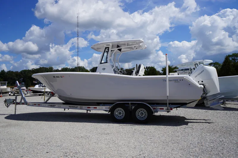 The Image of 2025 Tidewater 272 LXF boat on trailer under a blue sky with clouds. - 1