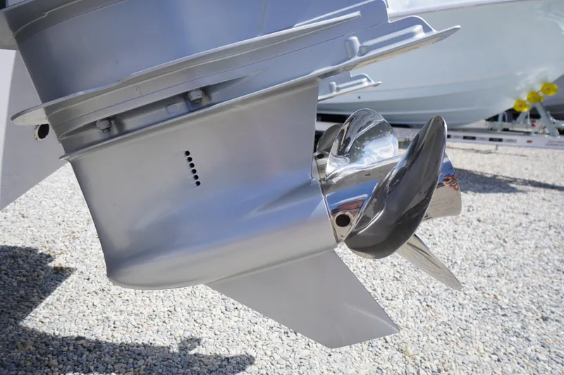 Slide: The Image of Close-up of a 2025 Tidewater 272 LXF boat propeller on gravel surface. - 12
