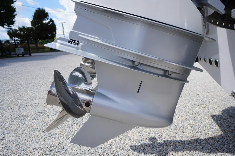 Slide: The Image of Close-up of 2025 Tidewater 272 LXF boat propeller on gravel surface. - 13