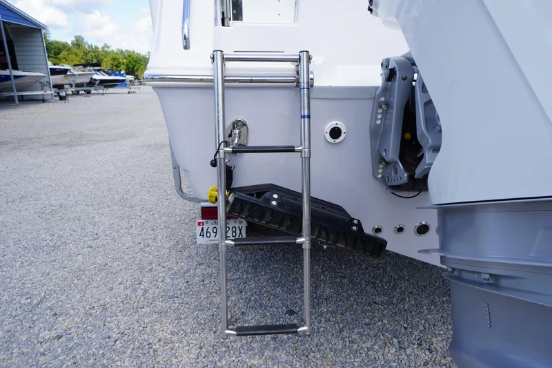 Slide: The Image of 2025 Tidewater 272 LXF boat with rear ladder and outboard motor detail. - 16