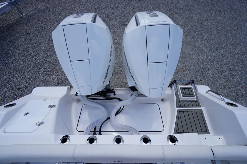 Slide: The Image of 2025 Tidewater 272 LXF boat with dual Mercury outboard engines, rear view. - 20
