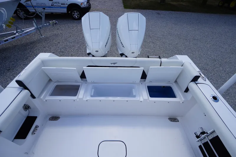 Slide: The Image of 2025 Tidewater 272 LXF boat deck with dual Mercury engines and storage compartments. - 23