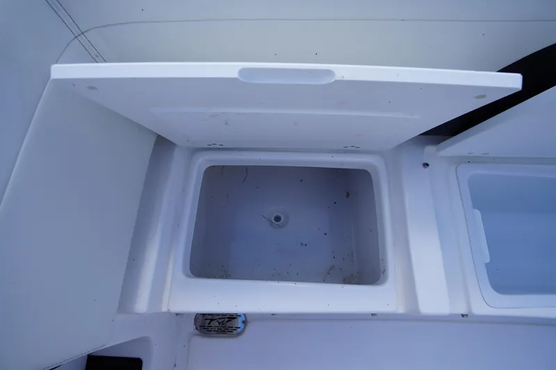 Slide: The Image of Open storage compartment on 2025 Tidewater 272 LXF boat, showcasing interior space. - 24