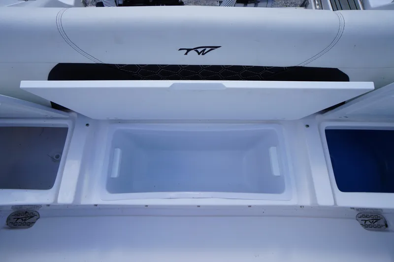 Slide: The Image of 2025 Tidewater 272 LXF boat storage compartment with open lid, showcasing interior space. - 25