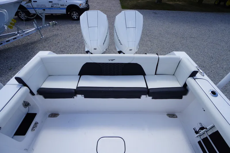 Slide: The Image of 2025 Tidewater 272 LXF boat interior with seating and dual Mercury engines. - 27