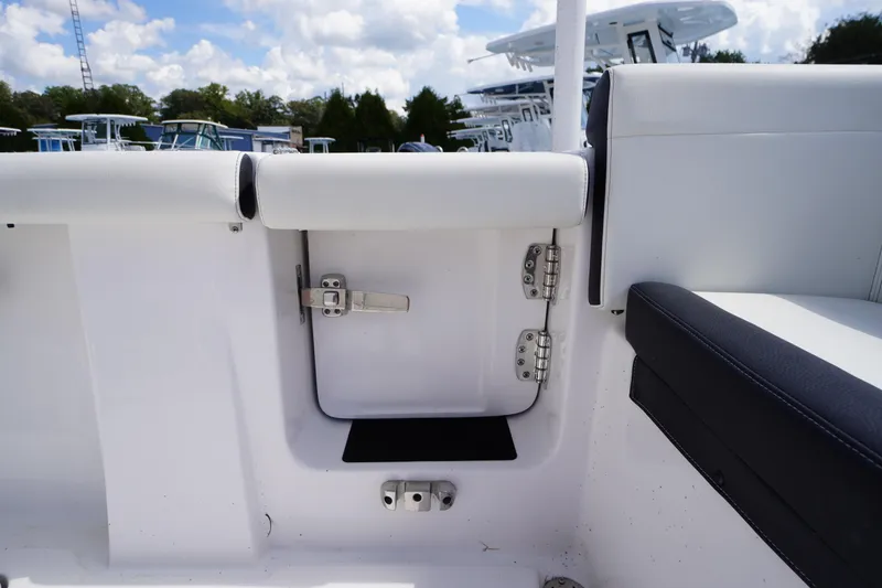 Slide: The Image of 2025 Tidewater 272 LXF boat interior with white seating and storage compartment. - 28