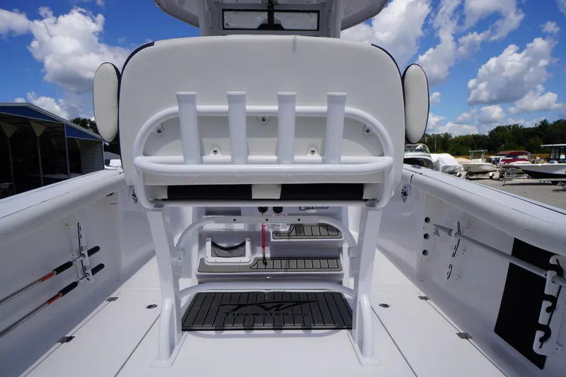 Slide: The Image of 2025 Tidewater 272 LXF boat interior with seating and rod holders under a blue sky. - 36