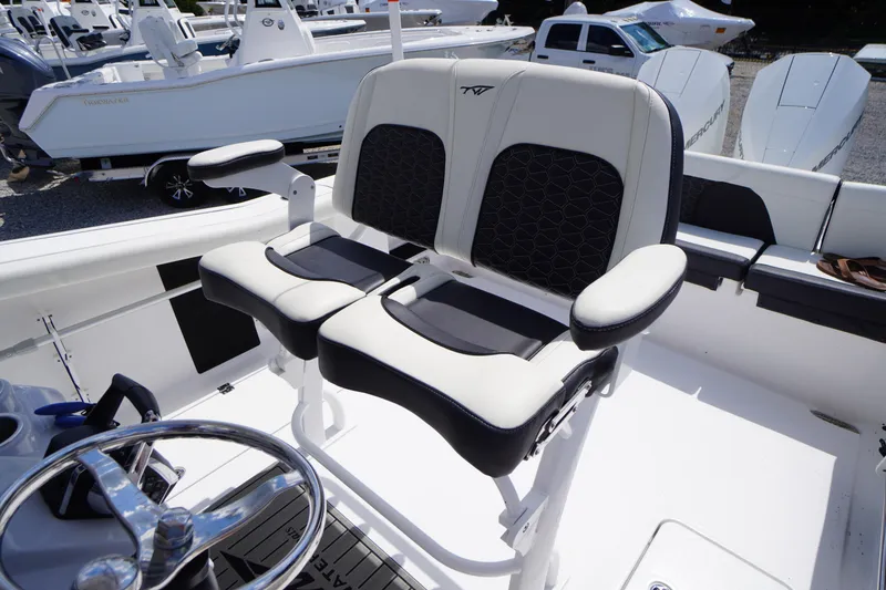 Slide: The Image of 2025 Tidewater 272 LXF boat interior with dual seating and steering wheel. - 38