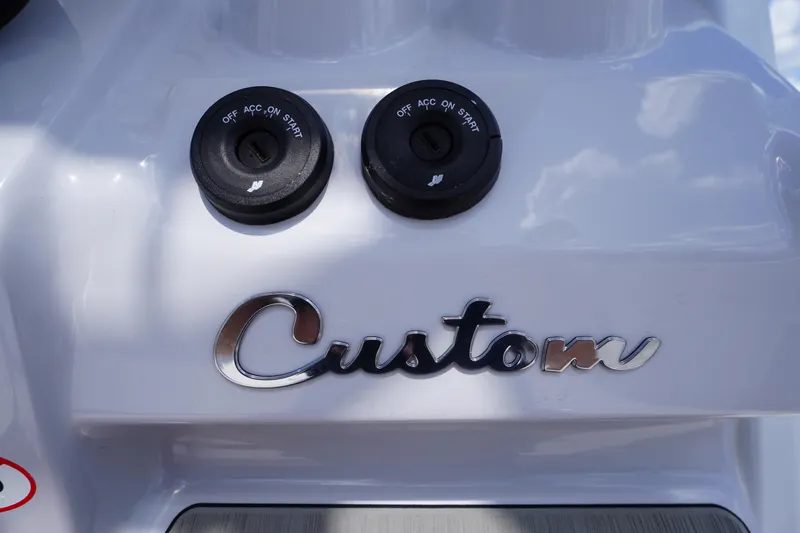 Slide: The Image of 2025 Tidewater 272 LXF boat dashboard with custom ignition switches. - 40
