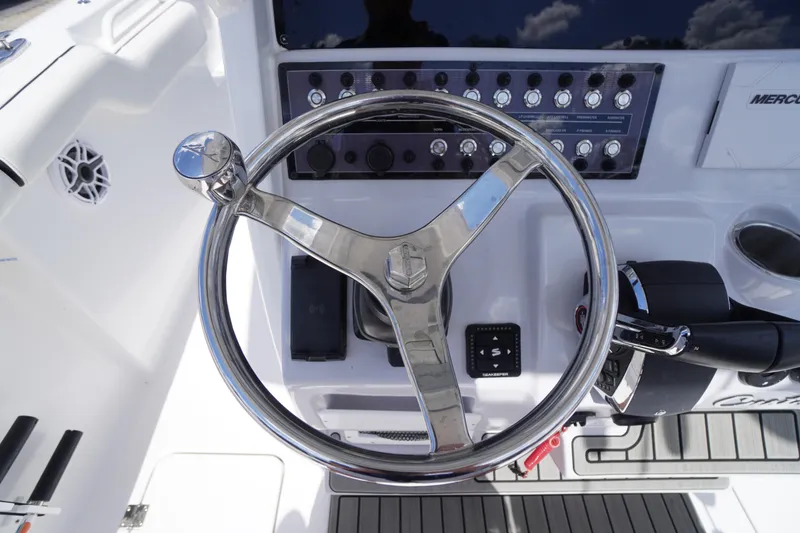 Slide: The Image of Steering wheel and controls of 2025 Tidewater 272 LXF boat cockpit. - 44