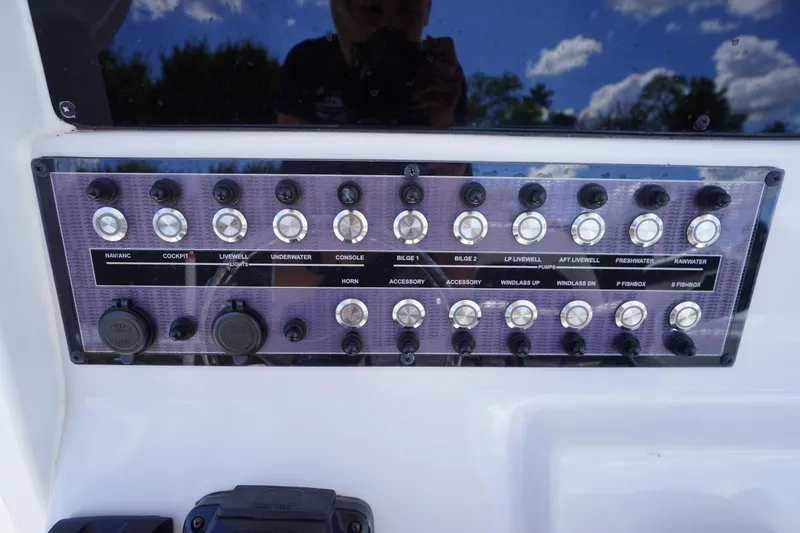 Slide: The Image of Control panel of 2025 Tidewater 272 LXF boat with various switches and USB ports. - 47