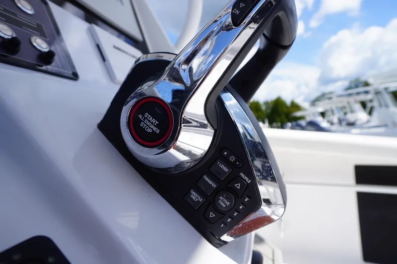 Slide: The Image of Close-up of 2025 Tidewater 272 LXF boat controls with start/stop button. - 49