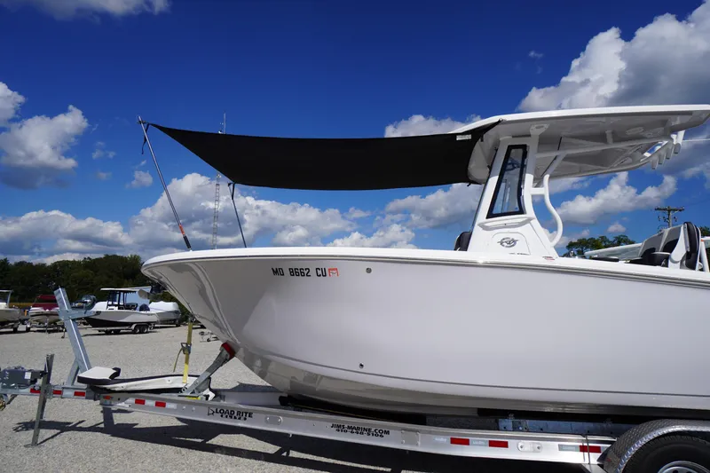 Slide: The Image of 2025 Tidewater 272 LXF boat on trailer under blue sky with clouds. - 5