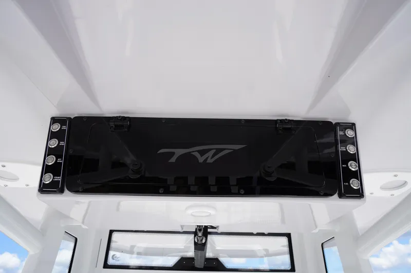 Slide: The Image of 2025 Tidewater 272 LXF boat console with control panel and logo, featuring modern design elements. - 55