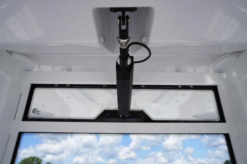 Slide: The Image of 2025 Tidewater 272 LXF boat windshield with clear sky reflection. - 56